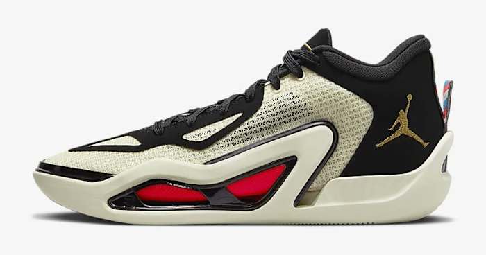 Side view of white, black, and red Jordan Tatum 1 sneakers.